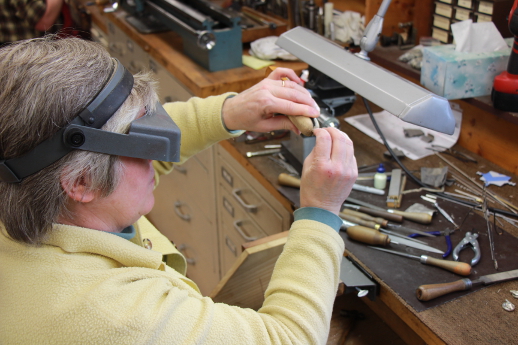 Mrs.Landell hand making a flute (Bench lathe on the left)